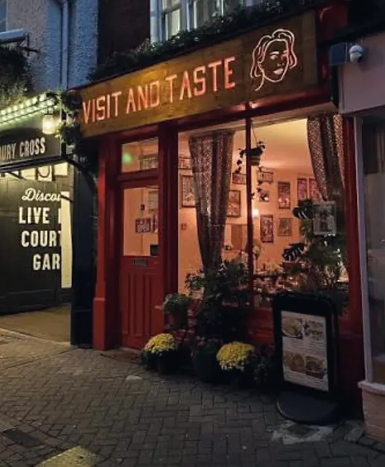 Visit and Taste café front in the evening